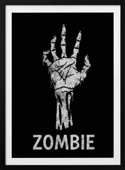 A black and white graphic of a distressed, skeletal zombie hand reaching up against a solid black background. Below the hand, the word 'ZOMBIE' is written in a bold, distressed font. The entire image is bordered by a thin black frame. Decor