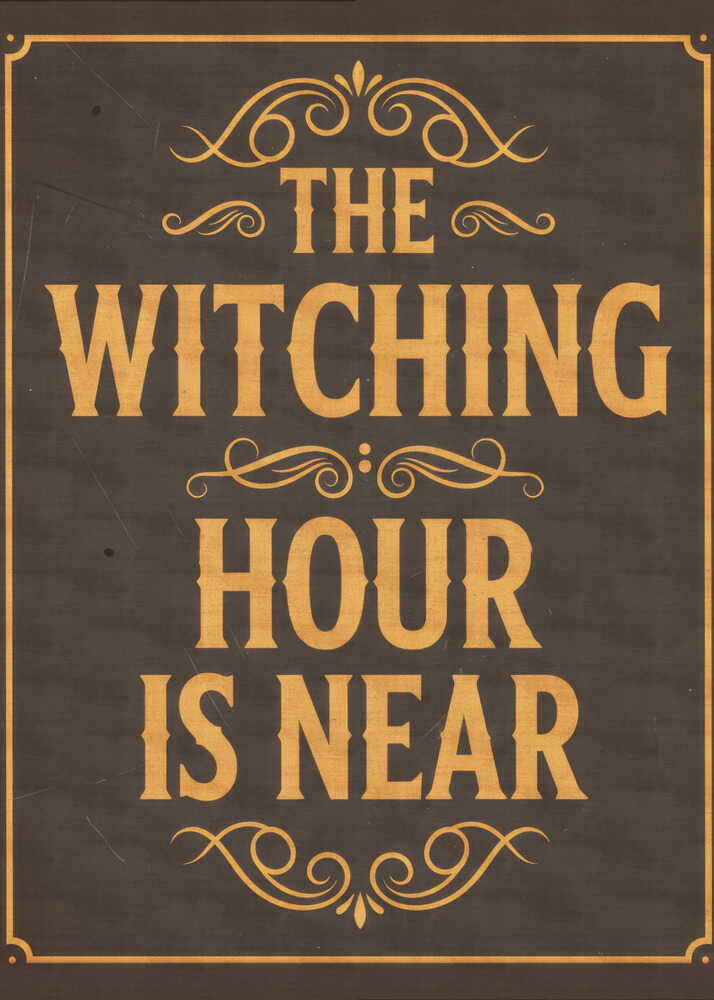A framed vintage-style sign with a dark brown, distressed background. In a bold, golden-yellow serif font, the text reads 'THE WITCHING HOUR IS NEAR'. The text is adorned with ornate, swirling flourishes above, between, and below the lines. A thin golden-yellow border frames the entire design. Poster