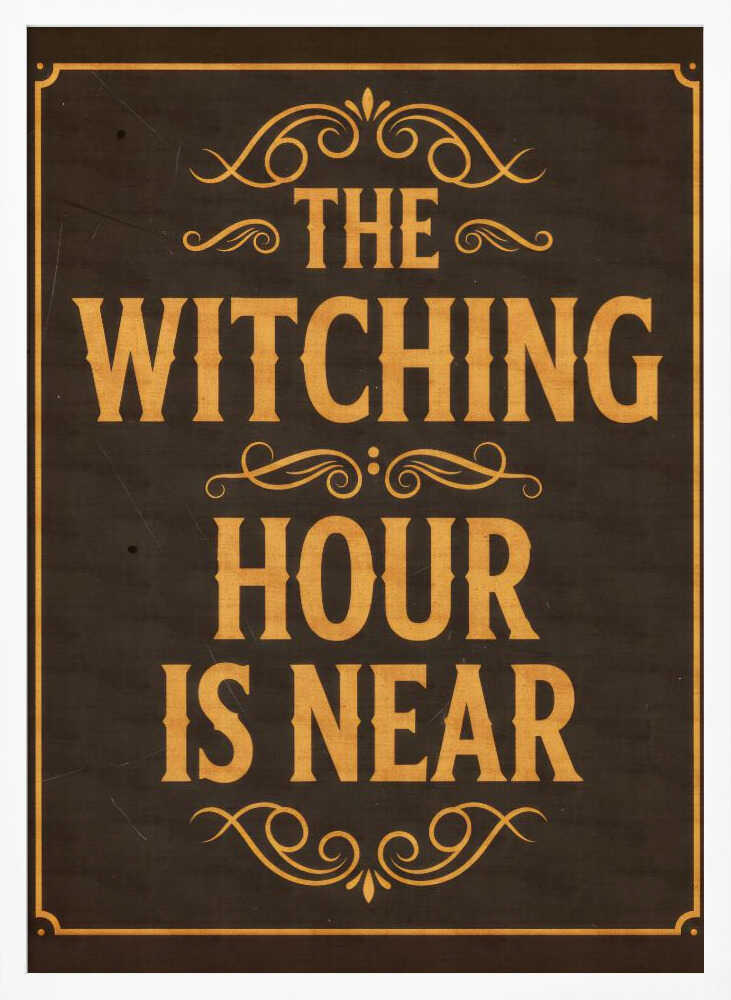 A framed vintage-style sign with a dark brown, distressed background. In a bold, golden-yellow serif font, the text reads 'THE WITCHING HOUR IS NEAR'. The text is adorned with ornate, swirling flourishes above, between, and below the lines. A thin golden-yellow border frames the entire design. Poster