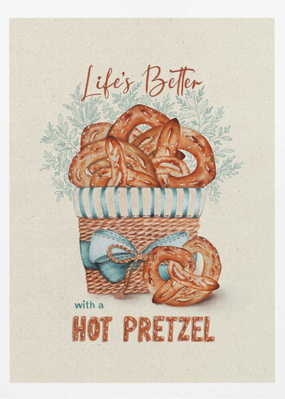 A vintage-style framed artwork featuring a watercolor illustration of a wicker basket overflowing with golden-brown pretzels. The text reads 'Life's Better with a HOT PRETZEL' in a warm brown font against a cream-colored textured background. A blue ribbon is tied around the basket, and light blue foliage is visible behind it. Poster