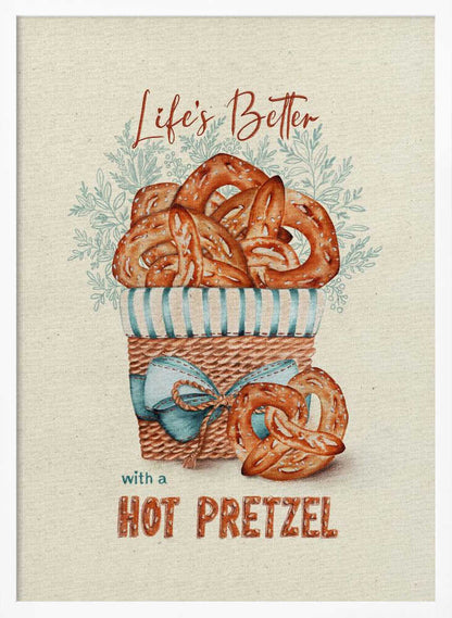 A vintage-style framed artwork featuring a watercolor illustration of a wicker basket overflowing with golden-brown pretzels. The text reads 'Life's Better with a HOT PRETZEL' in a warm brown font against a cream-colored textured background. A blue ribbon is tied around the basket, and light blue foliage is visible behind it. Poster
