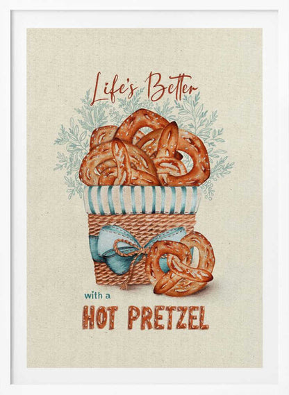 A vintage-style framed artwork featuring a watercolor illustration of a wicker basket overflowing with golden-brown pretzels. The text reads 'Life's Better with a HOT PRETZEL' in a warm brown font against a cream-colored textured background. A blue ribbon is tied around the basket, and light blue foliage is visible behind it. Poster