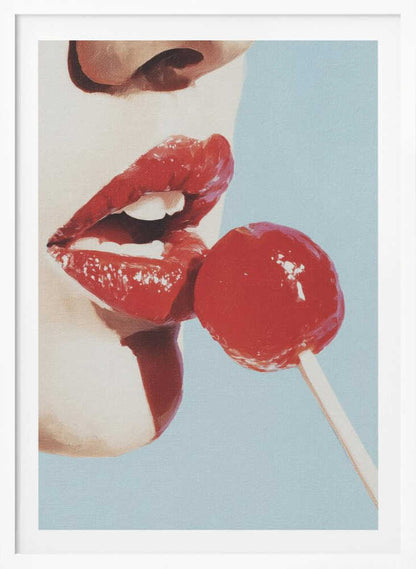 A pop art painting in a black frame, featuring a close-up of a woman's face in profile with bright red lipstick. Her lips are parted as she touches them to a round, red lollipop against a solid light blue background. Print