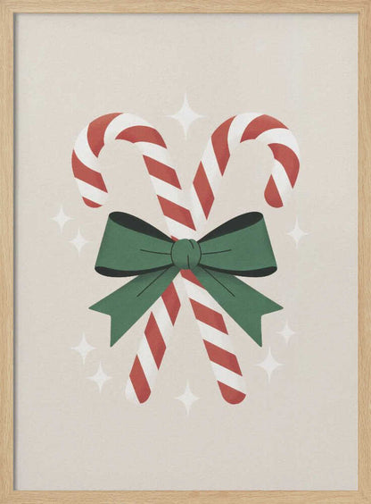 An illustration of two red-and-white striped candy canes crossed and tied together with a large green bow. The background is a soft beige color with small, white, four-pointed star sparkles. The artwork is shown in a black frame. Decor
