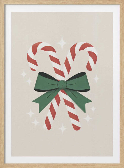An illustration of two red-and-white striped candy canes crossed and tied together with a large green bow. The background is a soft beige color with small, white, four-pointed star sparkles. The artwork is shown in a black frame. Decor
