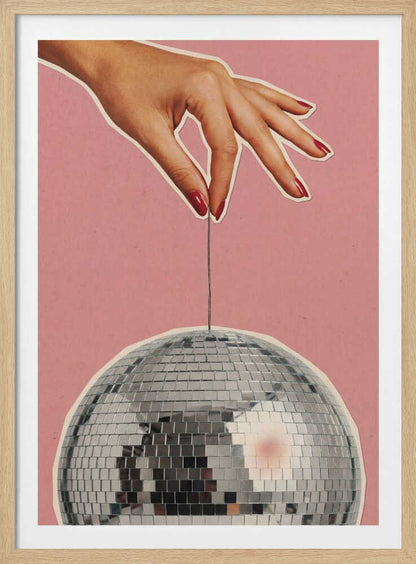 Retro collage art of a hand with red nails holding a silver disco ball against a pink background.