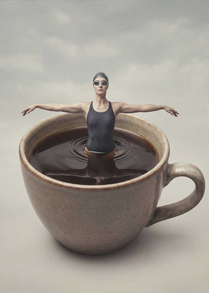 Surreal art print of a woman in a swimsuit swimming in a giant cup of coffee.