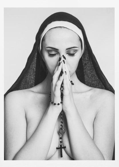 A black and white portrait of a woman with dramatic eye makeup wearing a nun's habit. Her eyes are closed and her hands are clasped in front of her face in prayer, holding a black rosary. Her shoulders are bare, creating a stark contrast. Artwork