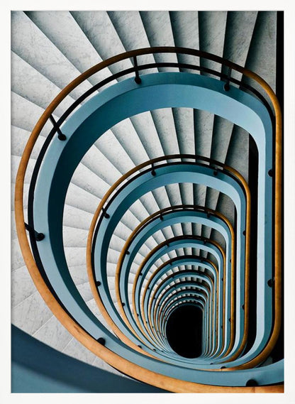 A high-angle, top-down photograph of a multi-story rectangular spiral staircase, creating a hypnotic, receding pattern. The steps are light gray marble, contrasted by shadows, and the balustrade is a striking light blue with a warm wooden handrail, leading down to a dark abyss at the center. Wall Art