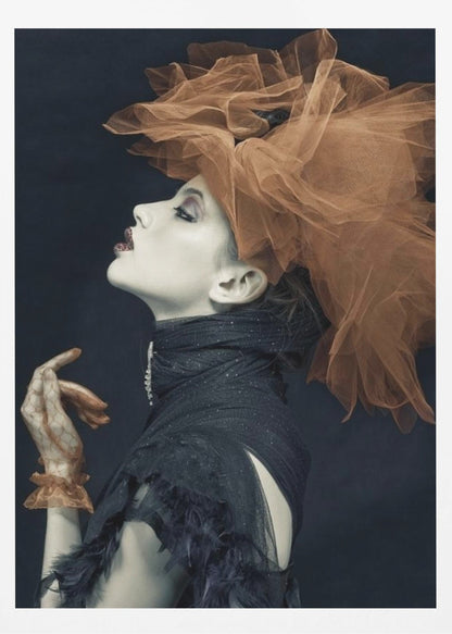 A dramatic profile portrait of a woman with pale skin against a black background, looking up. She wears an extravagant, voluminous orange tulle headpiece, a high-collared black feathered dress, and a matching orange glove. Poster