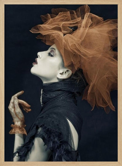 A dramatic profile portrait of a woman with pale skin against a black background, looking up. She wears an extravagant, voluminous orange tulle headpiece, a high-collared black feathered dress, and a matching orange glove. Poster