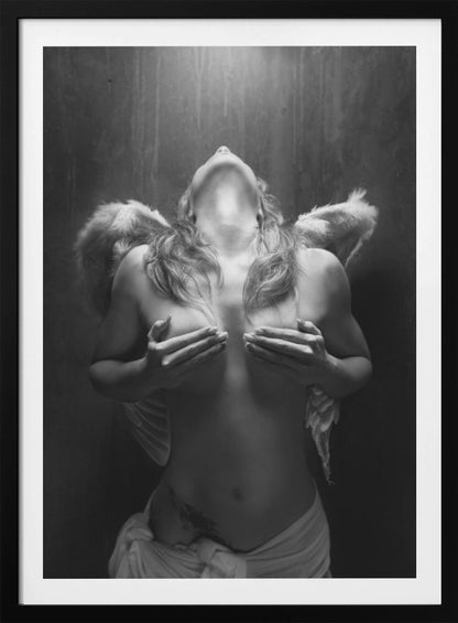 A dramatic black and white photograph of a topless woman with angel wings, her head tilted back towards a light from above. She is covering her breasts with her hands, and a white cloth is draped around her hips. Poster