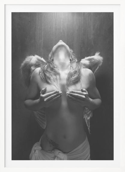 A dramatic black and white photograph of a topless woman with angel wings, her head tilted back towards a light from above. She is covering her breasts with her hands, and a white cloth is draped around her hips. Poster