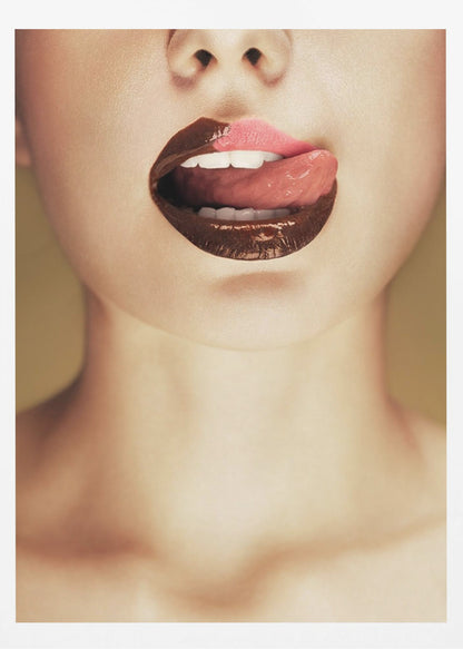 A close-up photograph of a woman's mouth with two-toned lipstick. The lips are mostly covered in glossy dark brown, with the upper right section in light pink. Her tongue is out, licking the pink part of her lip, revealing her white teeth. Print