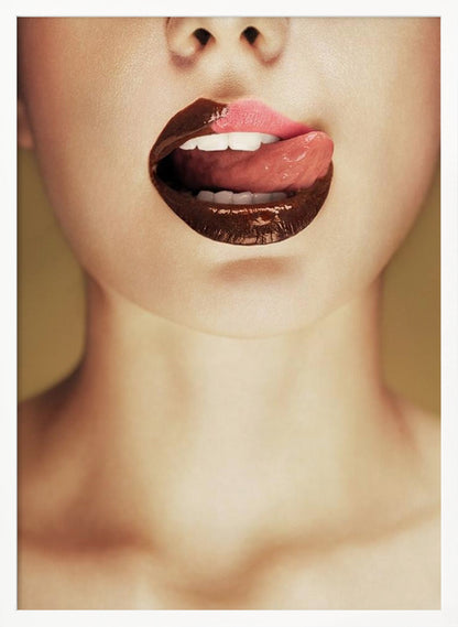A close-up photograph of a woman's mouth with two-toned lipstick. The lips are mostly covered in glossy dark brown, with the upper right section in light pink. Her tongue is out, licking the pink part of her lip, revealing her white teeth. Print