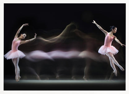 A long-exposure photograph capturing the fluid motion of a ballerina in a pink leotard and tutu. Two clear poses of the dancer frame a central, ethereal blur of movement against a dark, solid background, all encased in a silver frame. Artwork