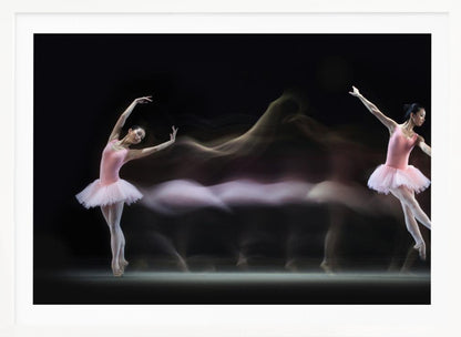 A long-exposure photograph capturing the fluid motion of a ballerina in a pink leotard and tutu. Two clear poses of the dancer frame a central, ethereal blur of movement against a dark, solid background, all encased in a silver frame. Artwork