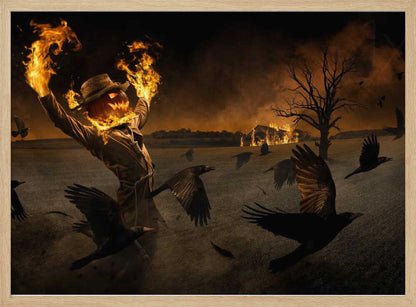 A terrifying scarecrow with a glowing jack-o'-lantern for a head stands in a dark field, its hands engulfed in flames raised towards the sky. A flock of black crows flies around it in a frenzy, while in the background, a barn burns under a dark, smoky orange sky. Wall Art