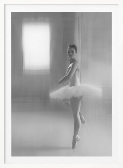 A black and white artistic photograph of a ballerina in a white leotard and tutu, mid-pose on pointe. The image has a motion blur effect, creating a dreamy and ethereal atmosphere as she glances back at the camera. Decor