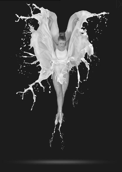 A dramatic black and white photograph of a ballerina suspended in mid-air against a black background. She is en pointe, and a dynamic splash of white liquid surrounds her, creating the illusion of wings. Artwork