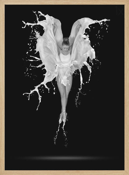 A dramatic black and white photograph of a ballerina suspended in mid-air against a black background. She is en pointe, and a dynamic splash of white liquid surrounds her, creating the illusion of wings. Artwork