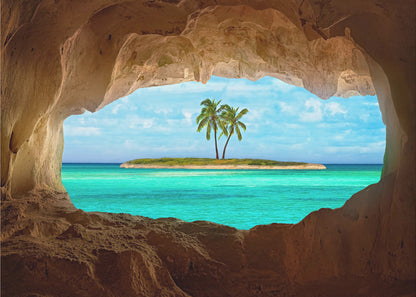 A framed artwork depicting a view from inside a rocky cave looking out at a small tropical island with two palm trees. The cave's natural arch frames the vibrant turquoise ocean and the bright blue sky, creating a sense of a hidden paradise. Artwork