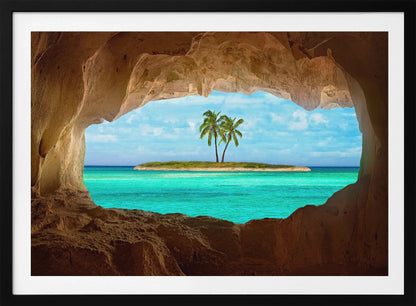 A framed artwork depicting a view from inside a rocky cave looking out at a small tropical island with two palm trees. The cave's natural arch frames the vibrant turquoise ocean and the bright blue sky, creating a sense of a hidden paradise. Artwork