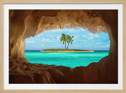 A framed artwork depicting a view from inside a rocky cave looking out at a small tropical island with two palm trees. The cave's natural arch frames the vibrant turquoise ocean and the bright blue sky, creating a sense of a hidden paradise. Artwork