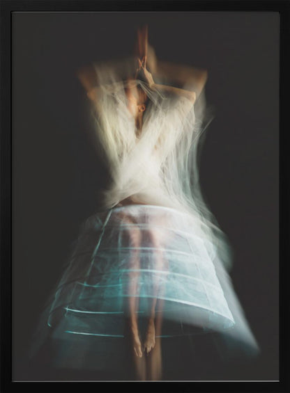 An ethereal, long-exposure photograph of a dancing figure against a dark gray background. The motion blur creates a ghostly effect, with white, gauzy fabric swirling around the upper body. The figure wears a transparent crinoline hoop skirt, revealing her legs and feet. Artwork