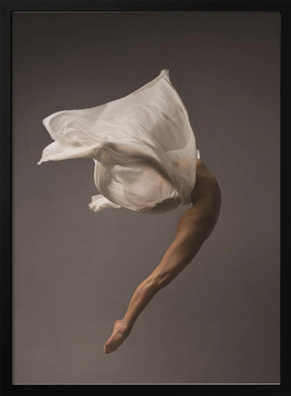 A minimalist fine art photograph of a dancer in mid-air against a solid grey background. The dancer's body is arched backwards, with a large piece of flowing white fabric enveloping their torso and creating a sense of dynamic, weightless motion. Only their muscular leg and pointed foot are clearly visible, emphasizing grace and form. Wall Art