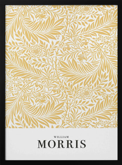 A framed exhibition-style poster of a William Morris design. The poster features an intricate, golden-yellow floral and leaf pattern on a white background. Below the pattern, the name 'WILLIAM MORRIS' is printed in black text. The entire artwork is presented in a simple black frame. Wall Art