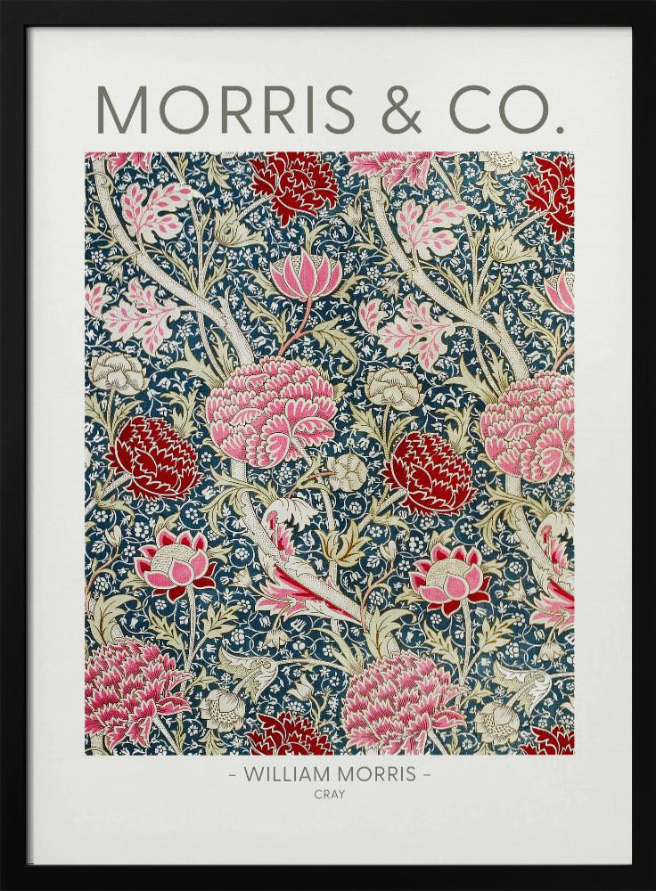A framed art print of William Morris's 'Cray' pattern, featuring a dense floral design with large pink and red stylized flowers and foliage on a dark navy blue background. The text 'MORRIS & CO.' is above the pattern, and '- WILLIAM MORRIS - CRAY' is below. Artwork
