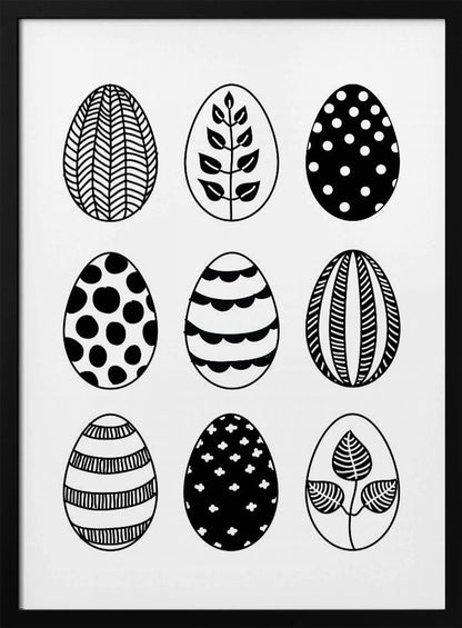 A black and white art print featuring a 3x3 grid of nine illustrated Easter eggs. Each egg has a unique, hand-drawn pattern, including polka dots, stripes, chevrons, florals, and leafy branches, all within a thin black frame. Poster