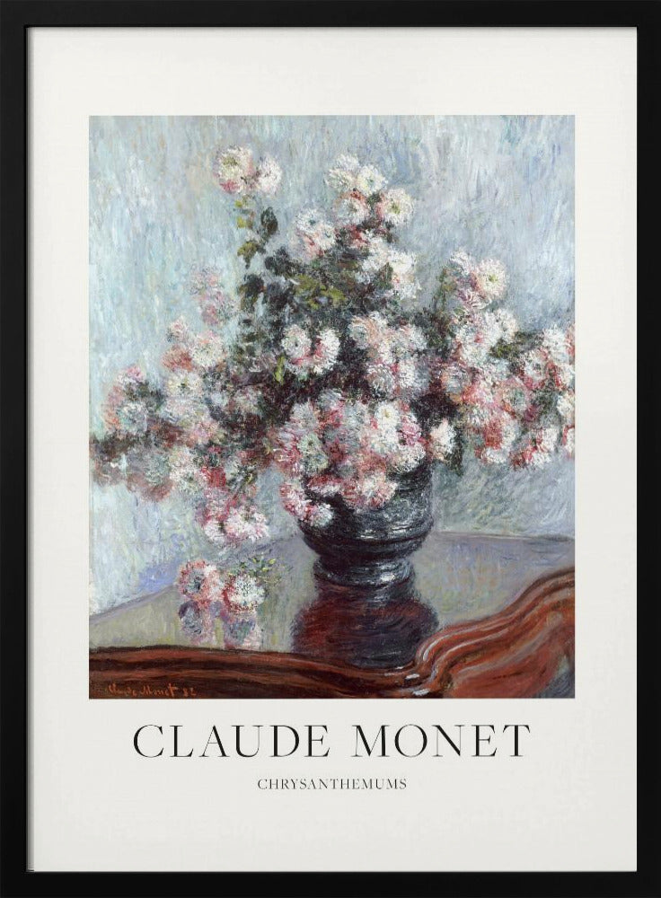 A framed art print of Claude Monet's impressionist painting, 'Chrysanthemums.' The painting features a lush bouquet of pink and white chrysanthemums in a dark vase resting on a reflective, mahogany-colored table against a light blue, textured background. The print includes a white border with the artist's name and the title below the artwork, all enclosed in a simple black frame. Print