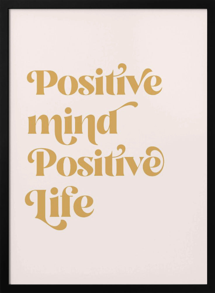 A framed art print featuring the motivational quote 'Positive mind Positive life' in a gold, retro-style font against a light pink background. The text is centered and arranged vertically. Artwork