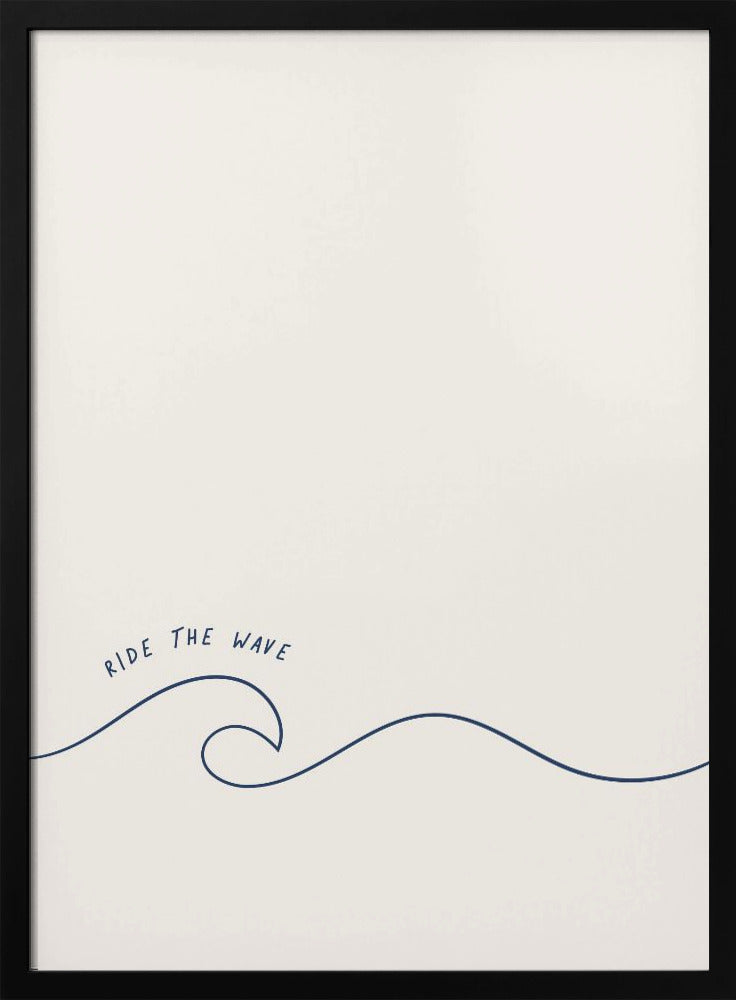 A minimalist art print in a black frame featuring a single dark blue line that forms a simple ocean wave on an off-white background. The words 'RIDE THE WAVE' are written in a casual, handwritten font above the crest. Wall Art
