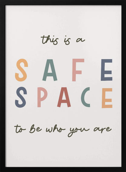 A framed poster with an inspirational message that reads 'this is a SAFE SPACE to be who you are'. The words 'SAFE SPACE' are in large, block letters of various muted colors like orange, sage, pink, and blue, while the rest of the text is in a smaller, dark green script font on an off-white background. Poster