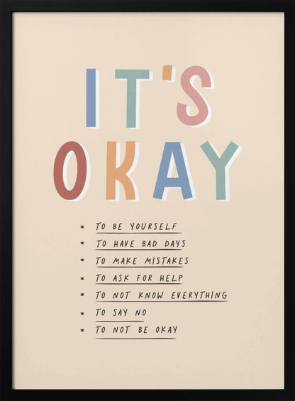 An inspirational framed poster with the words 'IT'S OKAY' in large, colorful letters. Below is a list of affirmations including 'TO BE YOURSELF', 'TO HAVE BAD DAYS', and 'TO MAKE MISTAKES' on a beige background. Artwork