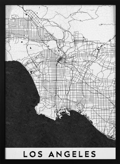 A minimalist black and white framed poster of a street map of Los Angeles. The land is white with an intricate grid of black lines representing roads and highways, while the Pacific Ocean is a solid, textured black. A white band at the bottom contains the city's name, 'LOS ANGELES', in a bold, black sans-serif font. Decor