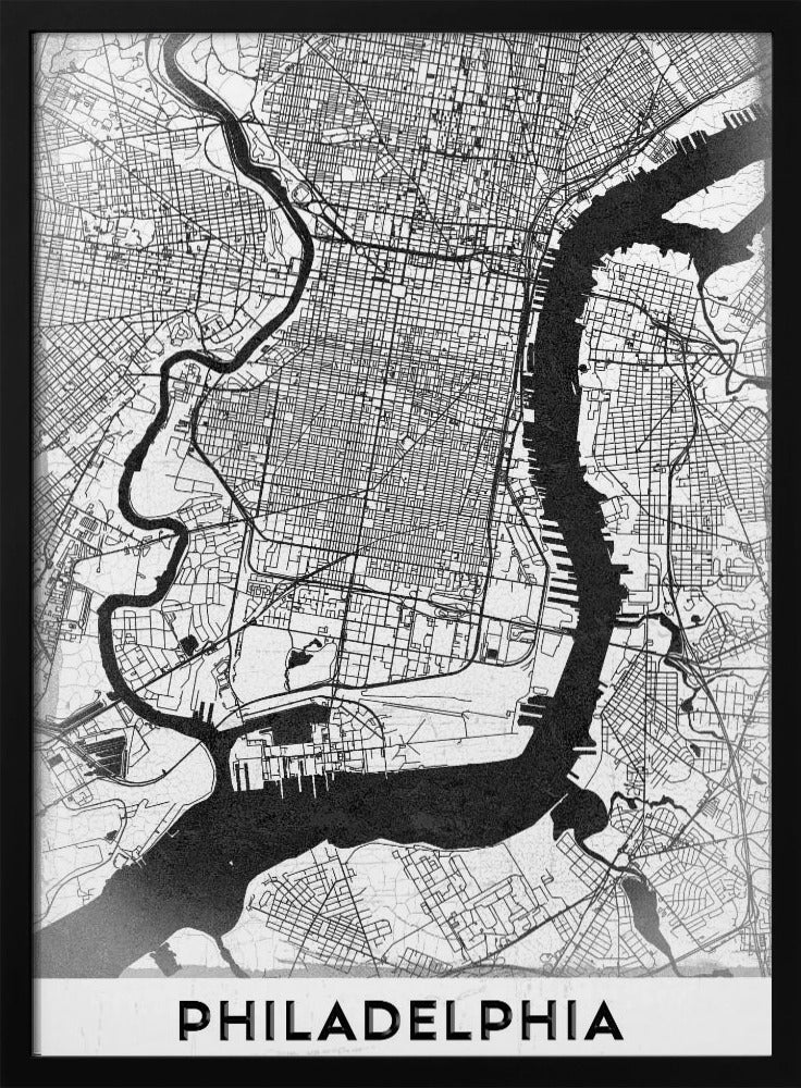 A modern black and white framed poster of a city map of Philadelphia. The map details the street grid, with the Schuylkill and Delaware rivers prominently featured in solid black. The word 'PHILADELPHIA' is printed in a bold, black sans-serif font at the bottom. Artwork