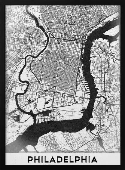A modern black and white framed poster of a city map of Philadelphia. The map details the street grid, with the Schuylkill and Delaware rivers prominently featured in solid black. The word 'PHILADELPHIA' is printed in a bold, black sans-serif font at the bottom. Artwork