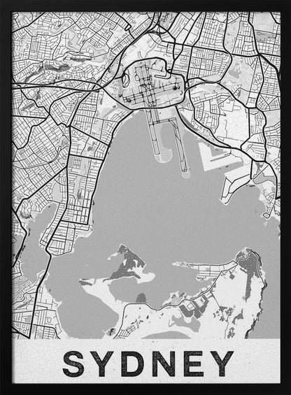 A modern, black and white framed art print of a stylized map of Sydney, Australia. The map features bold black lines for the street grid and major roads, with light grey for the landmass and a darker grey for the water of the harbor. The word 'SYDNEY' is printed in large, black, sans-serif font at the bottom of the poster. Poster