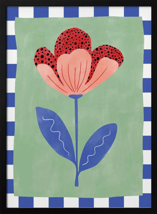 A framed illustration of a stylized flower with red polka-dotted and pink petals. The flower has a blue stem and two blue leaves, set against a sage green background with a blue and white checkered border. Artwork