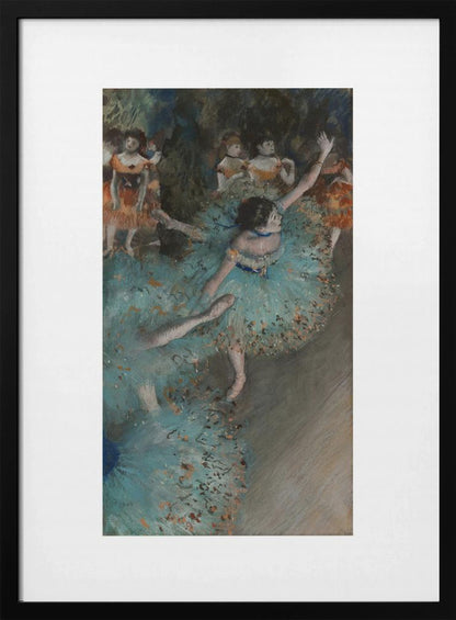 A framed art print of an impressionist painting depicting several ballet dancers on a stage. The central figure is a ballerina in a voluminous light blue tutu, viewed from a high angle. She is mid-pose with arms outstretched. Other dancers in orange and blue costumes are visible in the blurry background. Poster