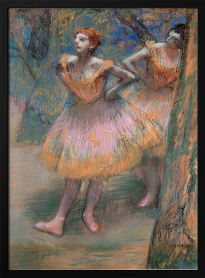 An impressionist pastel painting by Edgar Degas titled 'Dancers in Pink and Orange.' It depicts two ballerinas backstage. The dancer in the foreground has red hair, wears a pink and orange tutu, and stands with her hands on her hips, looking off to the side. A second dancer is partially visible behind her. The background is a textured blend of blues, greens, and browns. Artwork