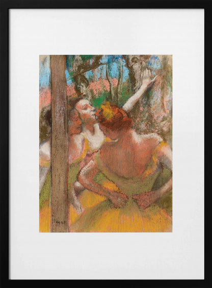 A framed art print of an impressionistic pastel painting by Edgar Degas featuring several ballet dancers backstage. A central figure, seen from behind, adjusts her yellow-green tutu while other dancers stretch in the background. Artwork