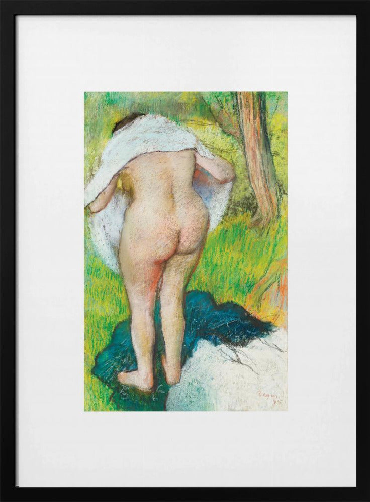 A framed pastel artwork by Edgar Degas showing the back of a nude woman as she dries herself with a white towel in a lush green landscape. The impressionist style is evident in the soft, textured application of color. Artwork