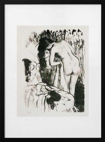 A framed black and white lithograph by Edgar Degas of a nude woman with long dark hair, viewed from the back as she leans over. The artwork has a sketchy, impressionistic style, capturing an intimate moment. Wall Art