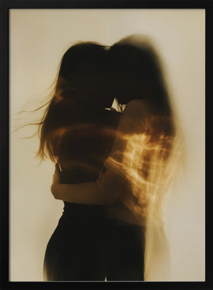 An artistic, long-exposure photograph of two silhouetted figures embracing. Their forms are blurred with motion, and streaks of warm, golden light wash over them against a soft, off-white background, creating a dreamy and intimate mood. Decor