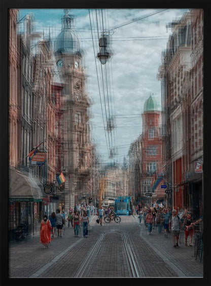 A motion-blurred, dreamlike photograph of a busy street in Amsterdam. Historic buildings line the cobblestone road, which is filled with pedestrians and features tram tracks. A prominent clock tower rises against a cloudy blue sky, and the entire scene has a shaky, layered effect. Poster
